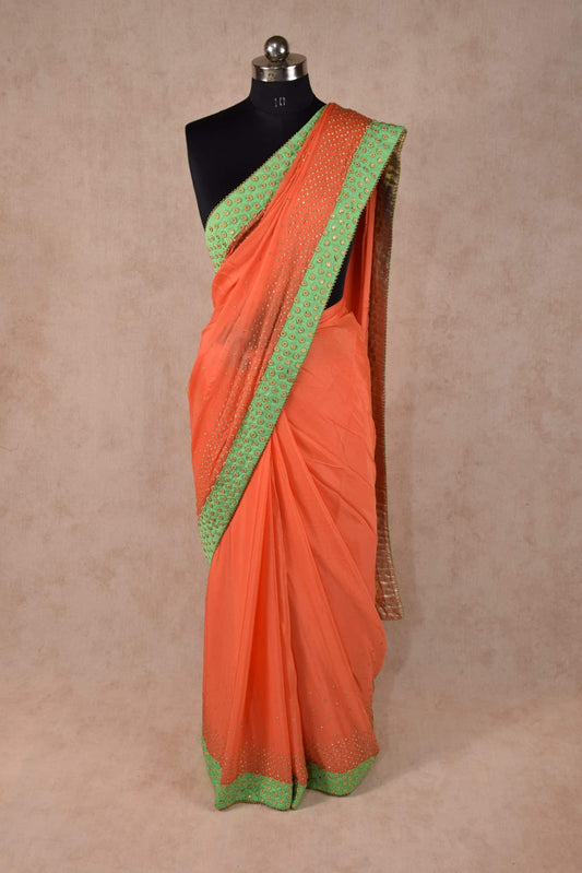Elegant Peach Color saree embellished with stone work and raw silk border - KANHASAREE