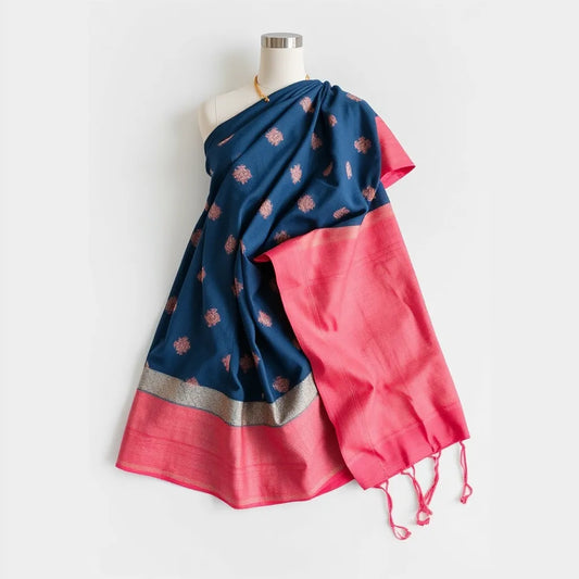 Deep blue and pink bandhani saree with neatly draped pallu and subtle border details on a clean studio backdrop
