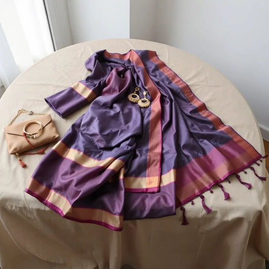 Silk saree with matching blouse and jewelry accessories arranged with elegant folds