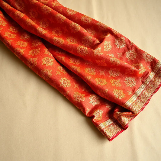Close-up of dense gold gota patti embroidery on rich fabric with neat stitched edges