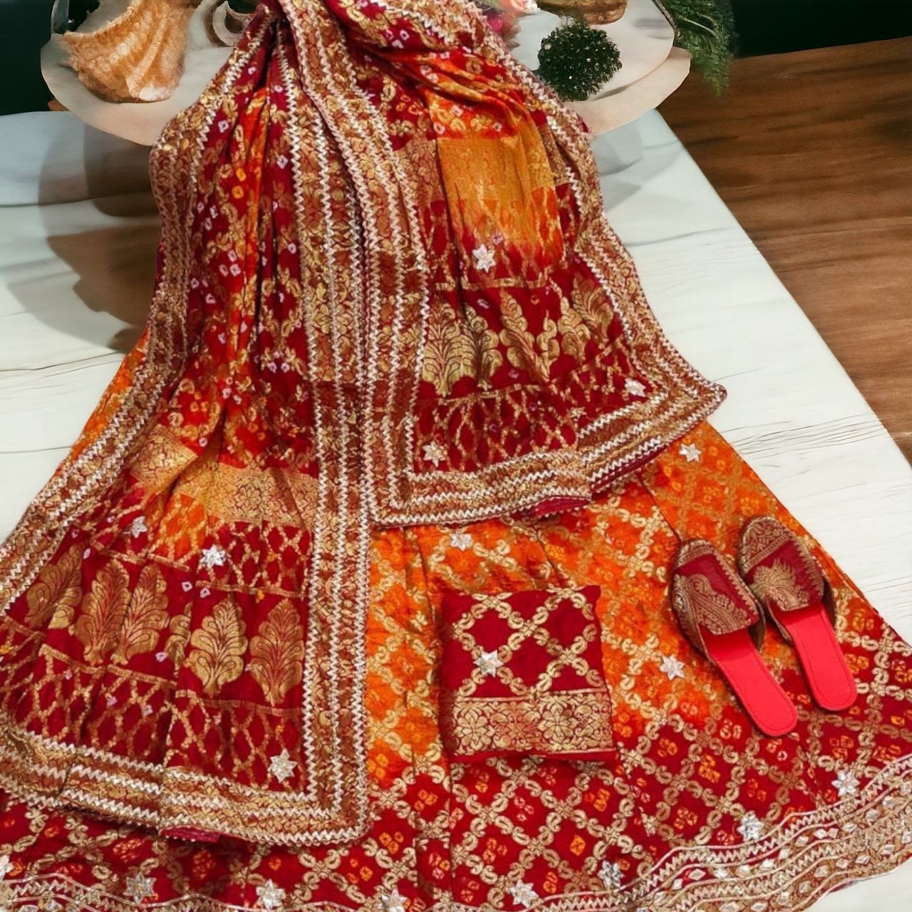 Vibhuti Jaipur - Red and Pink bandhani lehenga crafted with fusion of gota- patti and pittan work with bright pink border paired with magenta pink  blouse with gota-patti and pittan work. Orange and