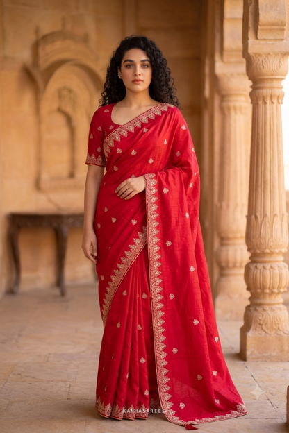 Vibrant red art silk saree, highlighting its traditional weave.