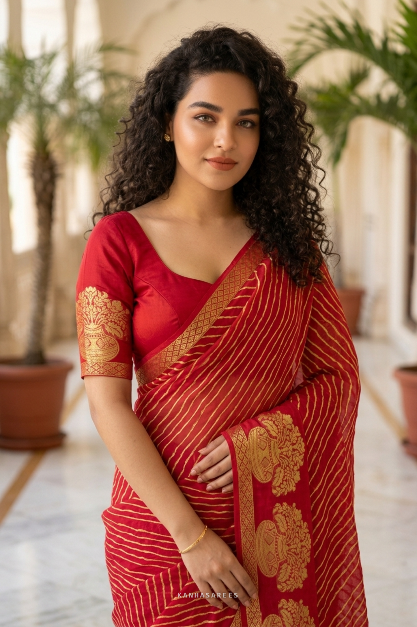 Full view of the red pure georgette leheriya saree with a gold zari border.