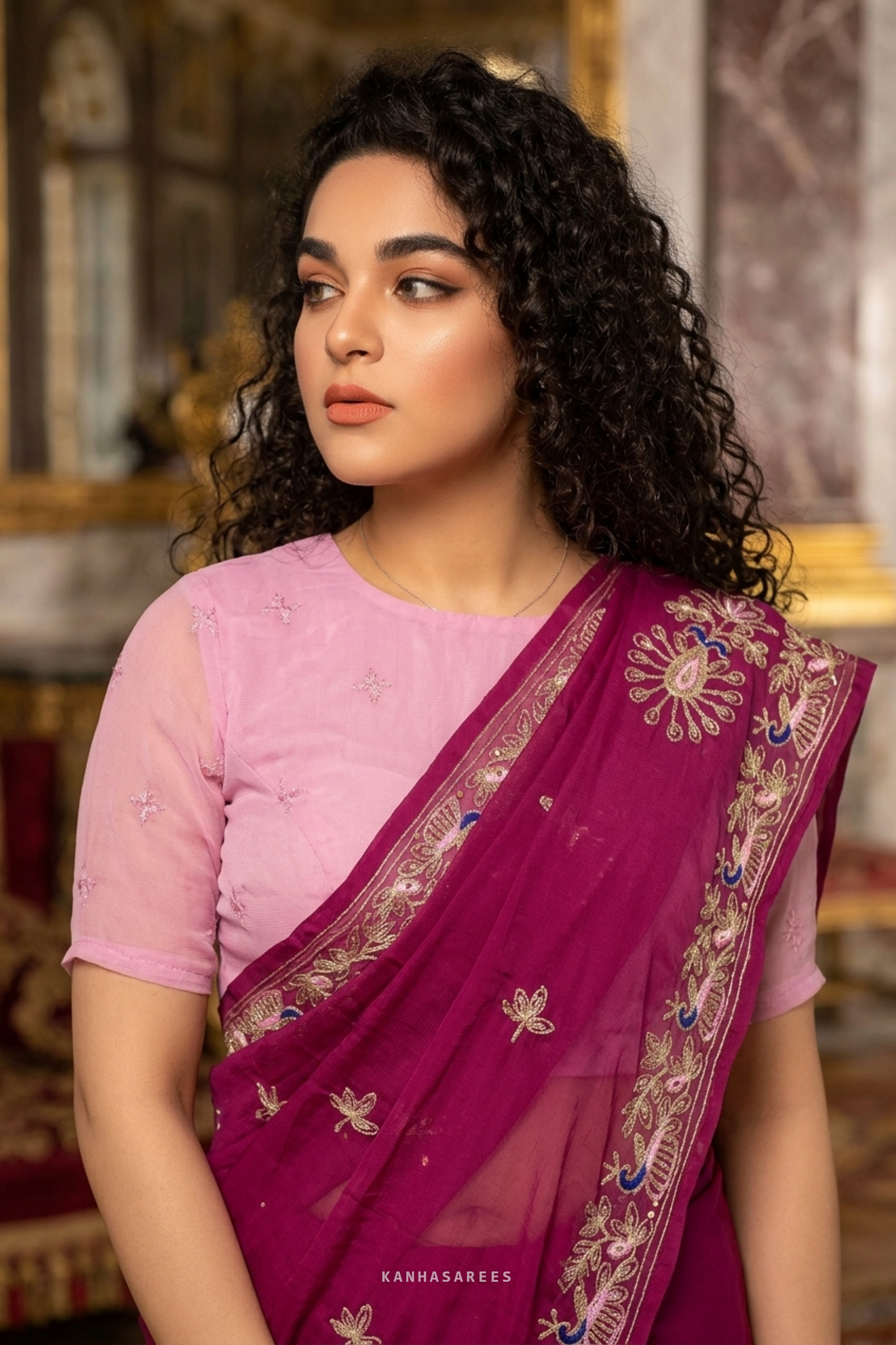 Deep pink Nazneen chiffon saree, folded to show fabric texture and embroidery detail.
