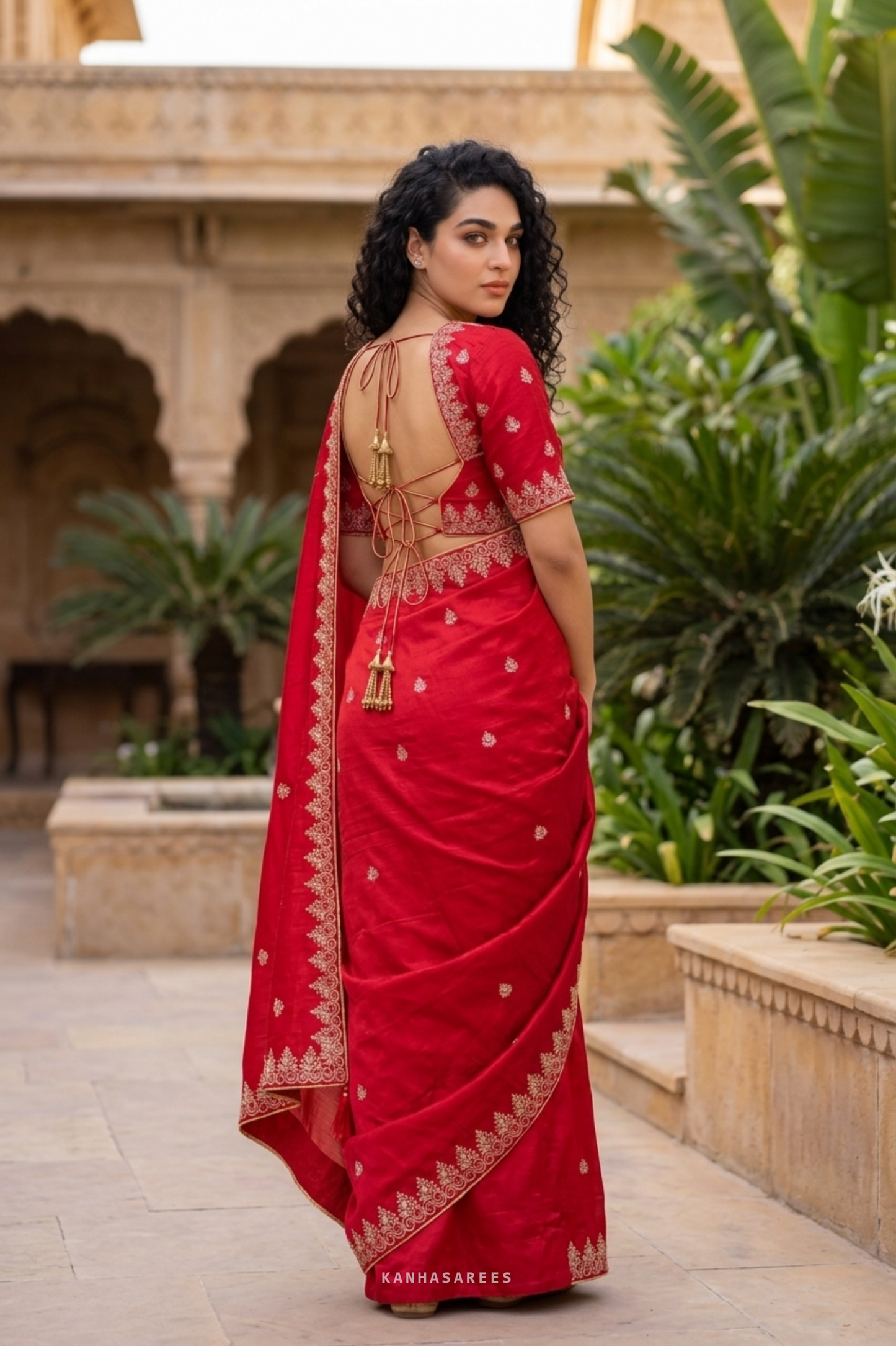 Close-up of the premium red art silk saree fabric.