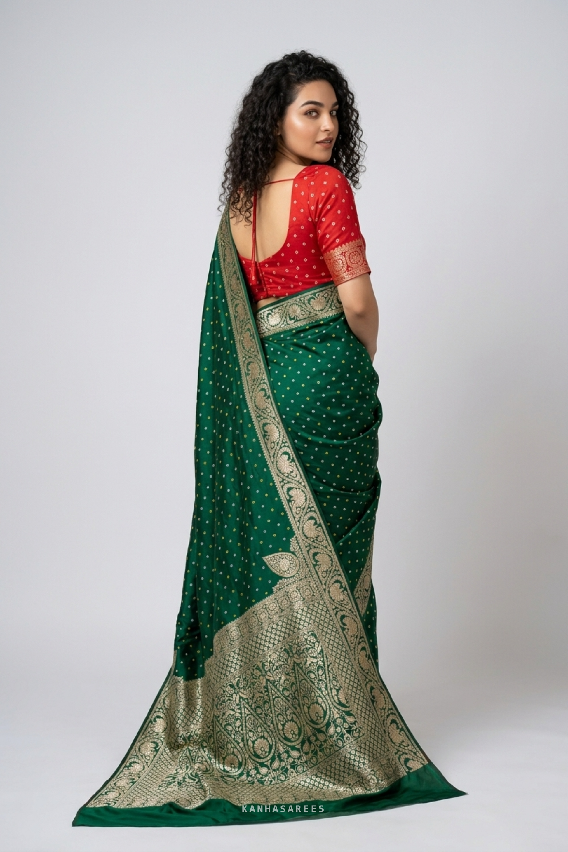 Green Dola silk saree, artfully draped to highlight its golden zari.