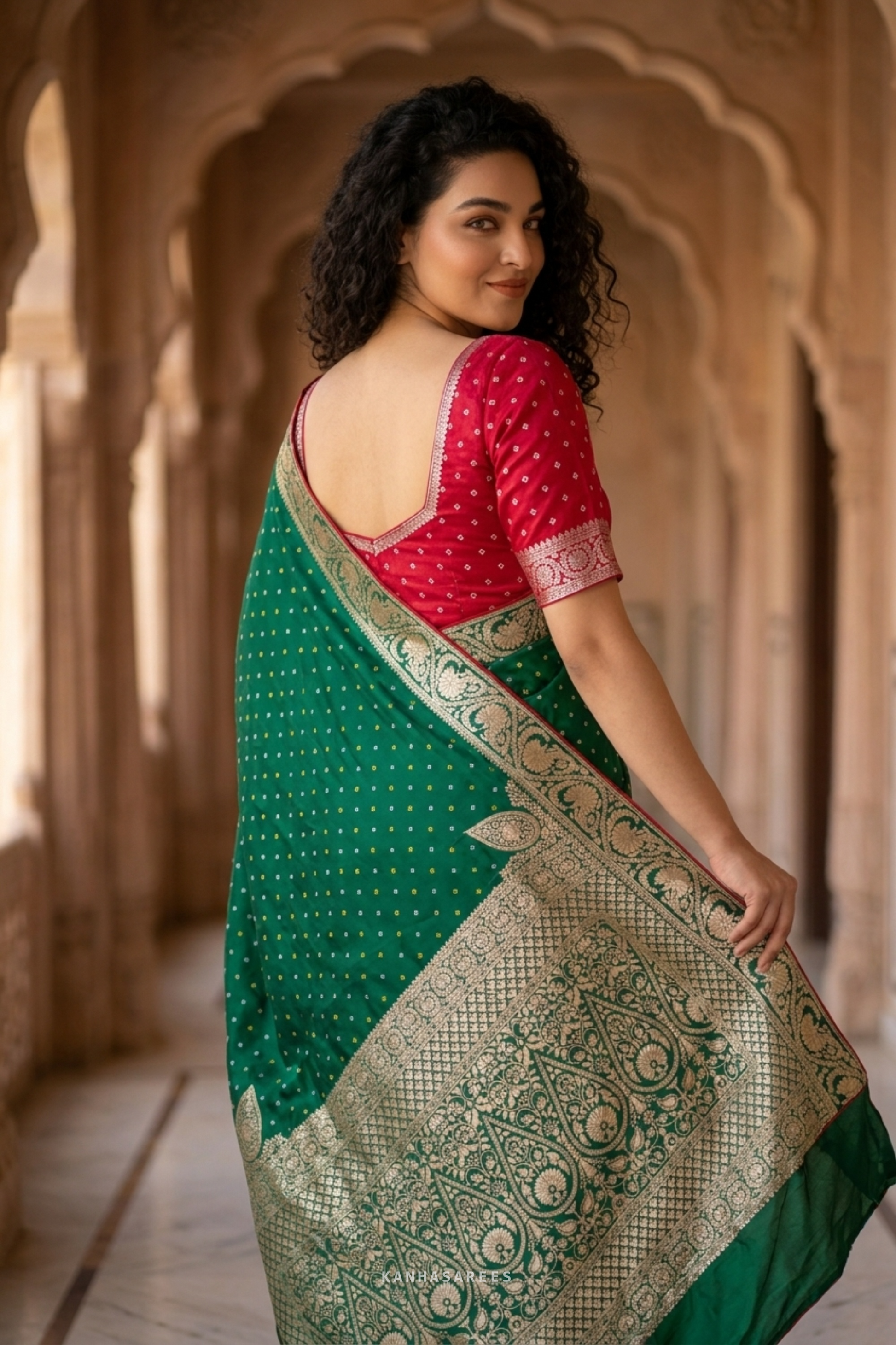 Elegant green Dola silk saree, folded to show its fabric and zari work.