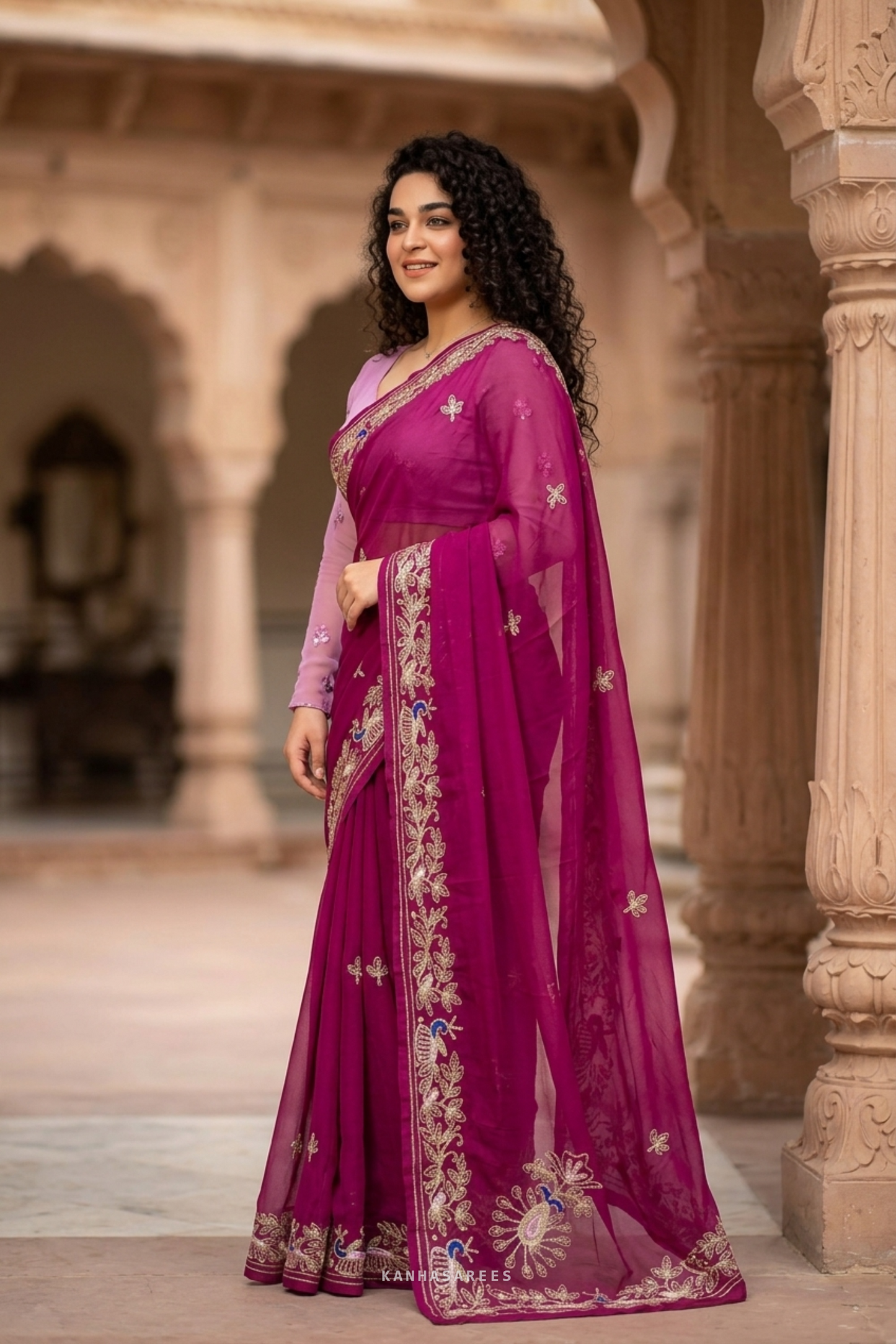 Close-up of the delicate handwork embroidery on the deep pink chiffon saree.