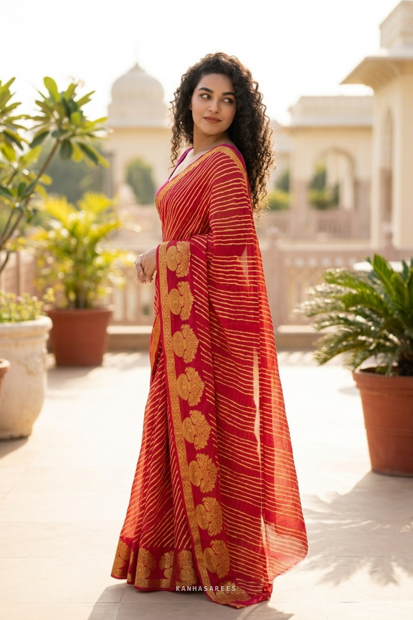Red and gold pure georgette leheriya saree, elegantly draped.