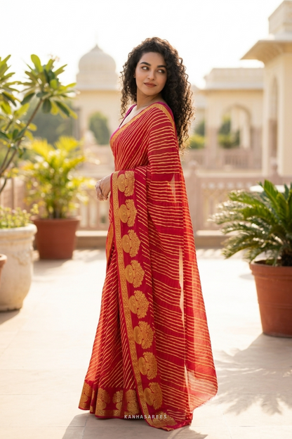Red and gold pure georgette leheriya saree, elegantly draped.