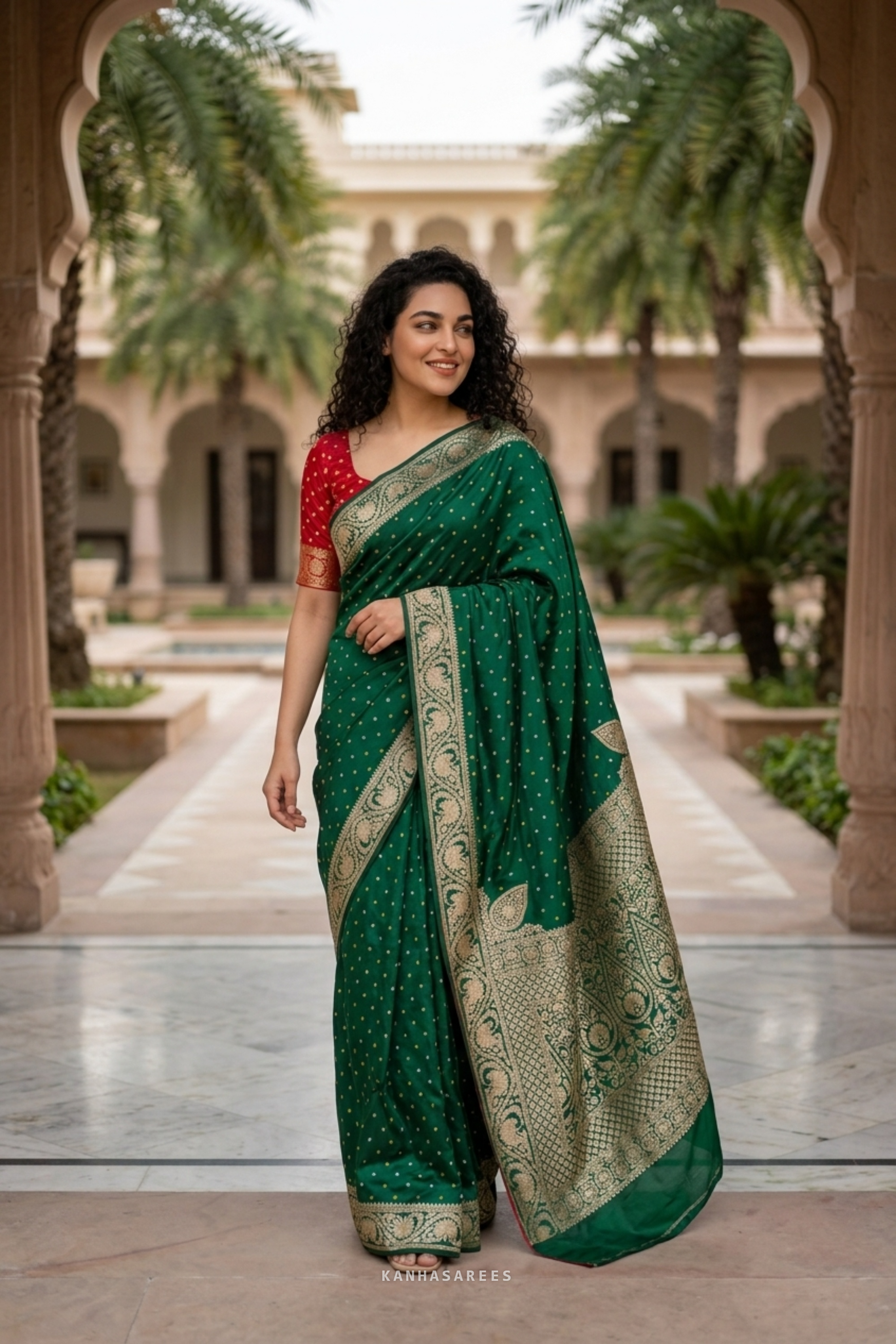 Detail of the green Dola silk saree's border with rich golden zari patterns.