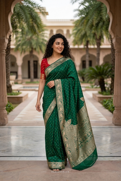 Detail of the green Dola silk saree's border with rich golden zari patterns.