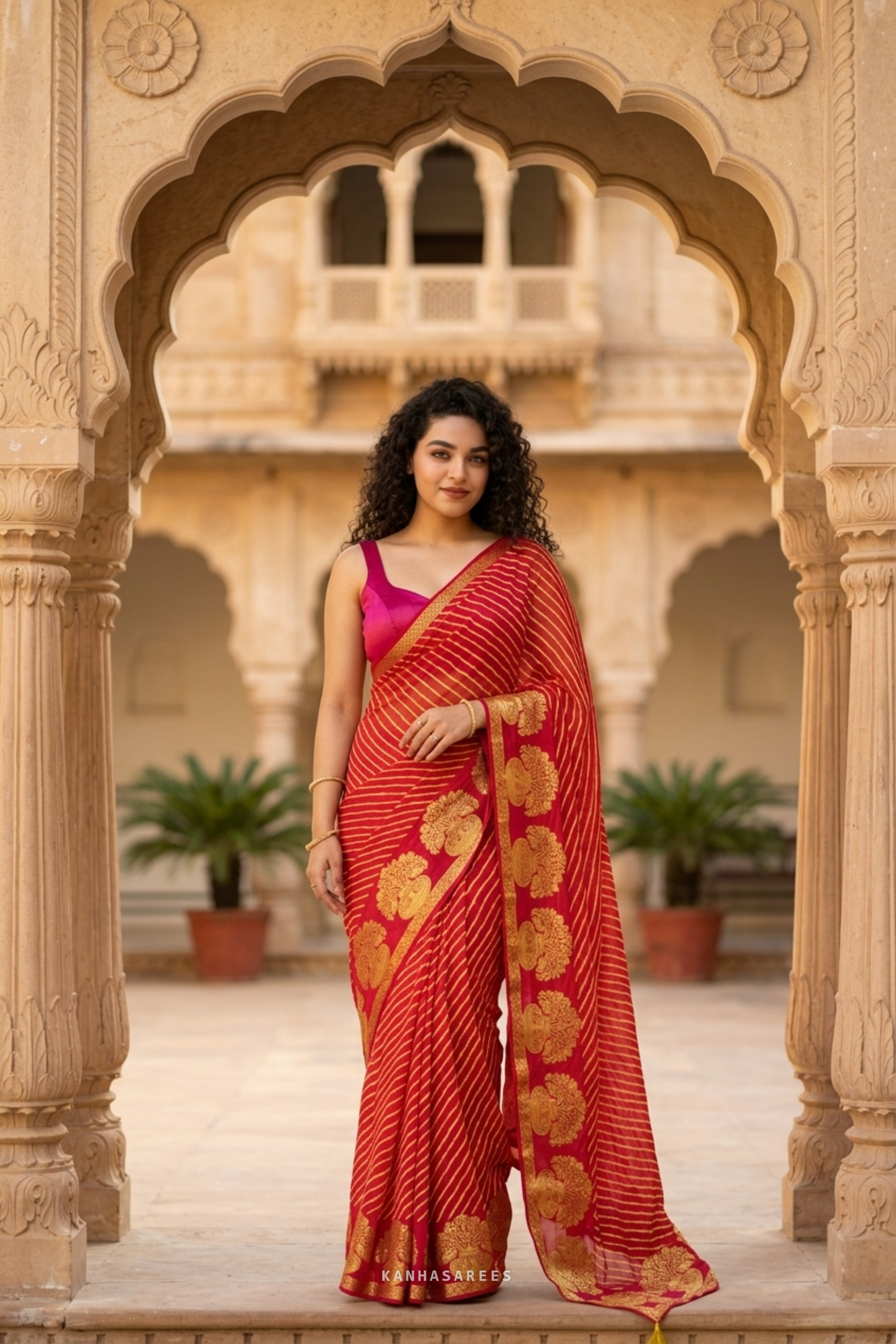 Close-up of the red pure georgette saree showing the leheriya pattern and gold zari work.