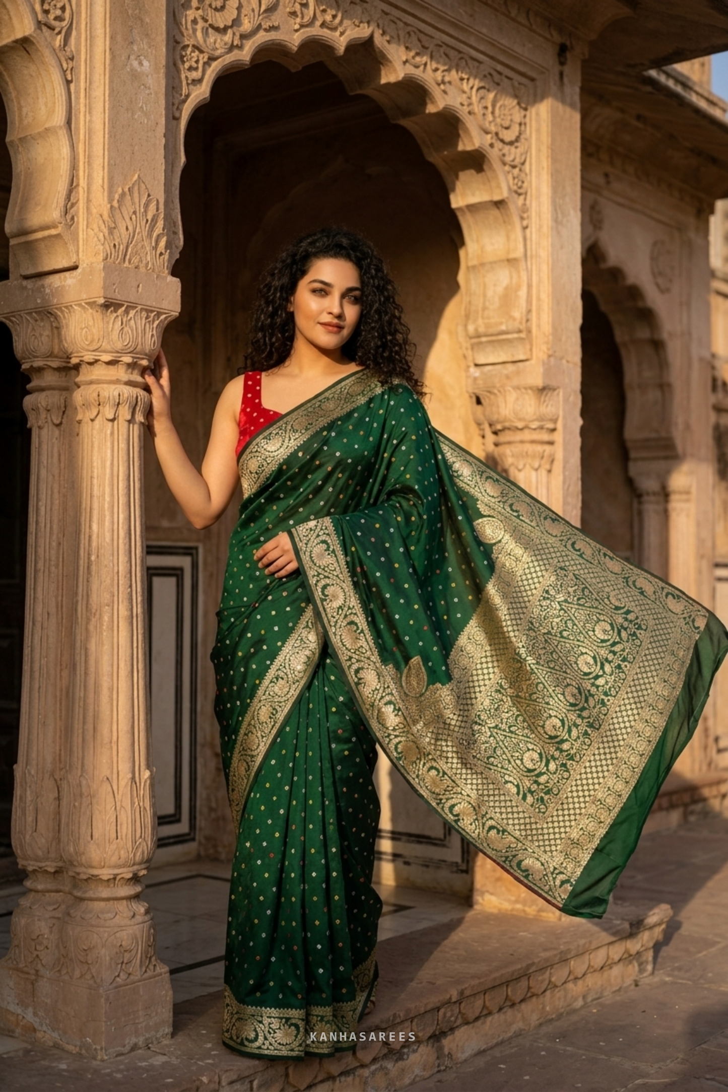 Close-up showing the shimmering golden zari work on green Dola silk.