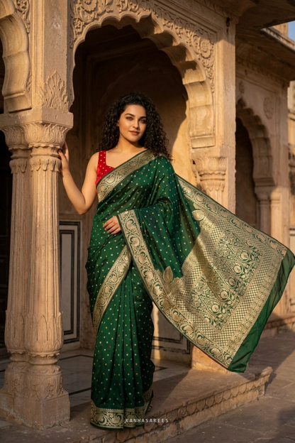 Close-up showing the shimmering golden zari work on green Dola silk.